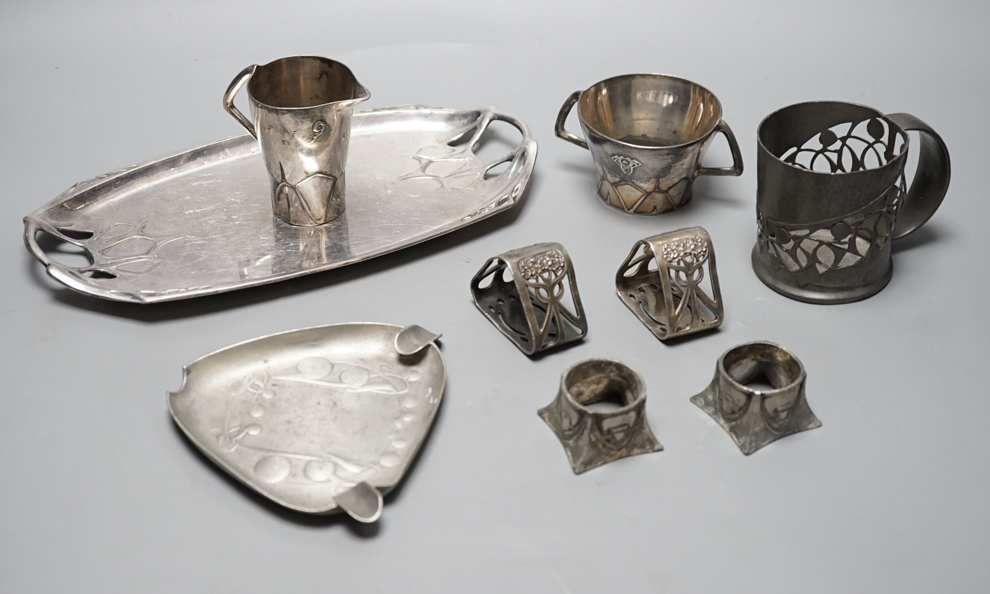 An Arts and Crafts Tudric pewter mug, stamped 534, a pair of WMF napkin rings together with other pewter and metal items, pewter mug 8cms high (9)